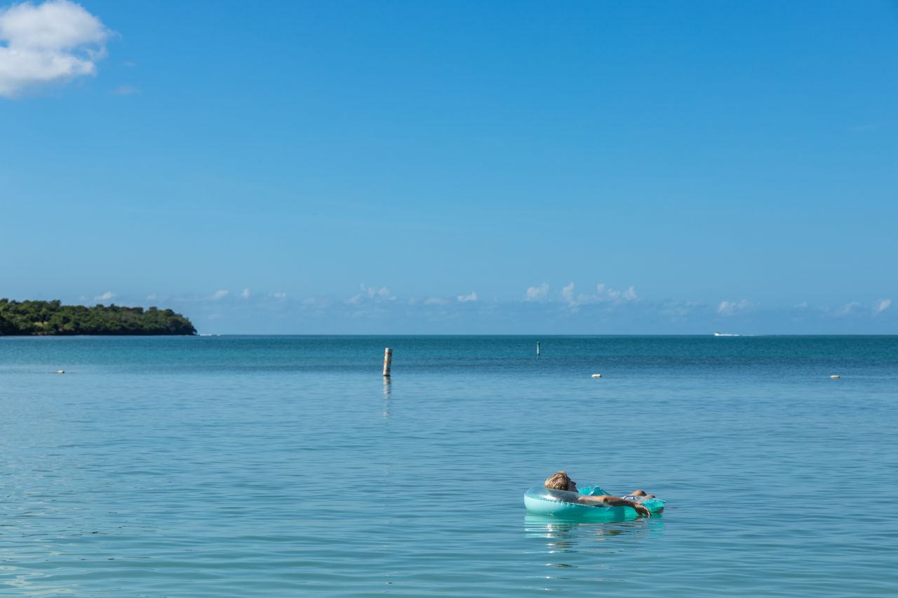 The Art of Drawing Readers In: Your attractive post title goes here A tranquil scene of a woman relaxing on a float in the beautiful turquoise waters of Cabo Rojo, Puerto Rico.